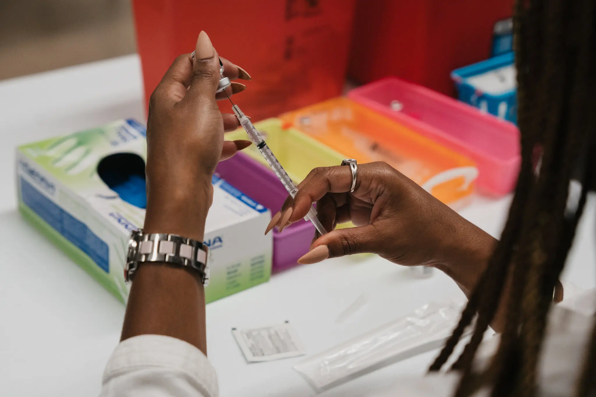 Image of someone drawing up a vaccine in a needle